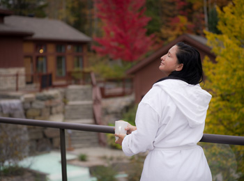 Femme en robe de spa sur le bord des installations thermales.